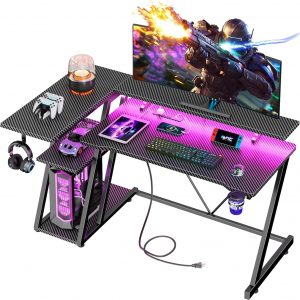 Korfile 47 Inch Gaming Desk with Power Outlet & LED Lights, Corner Computer Desk with 3 Tiers Storage Shelves, Home Office Desk with Monitor Stand for Small Space, Carbon Fiber Black
